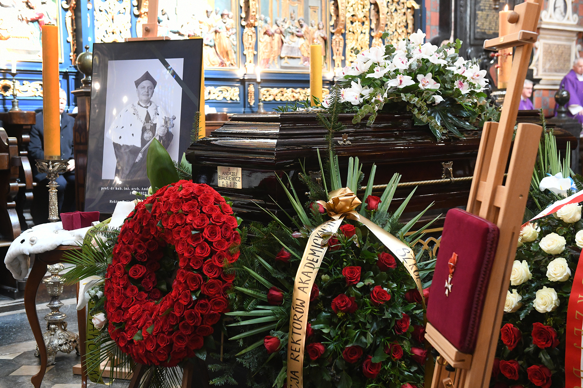 trumna z portretem ś.p. rektora Andrzeja Białkiewicza we wnętrzu Kościoła Mariackiego z wieńcami kwiatów